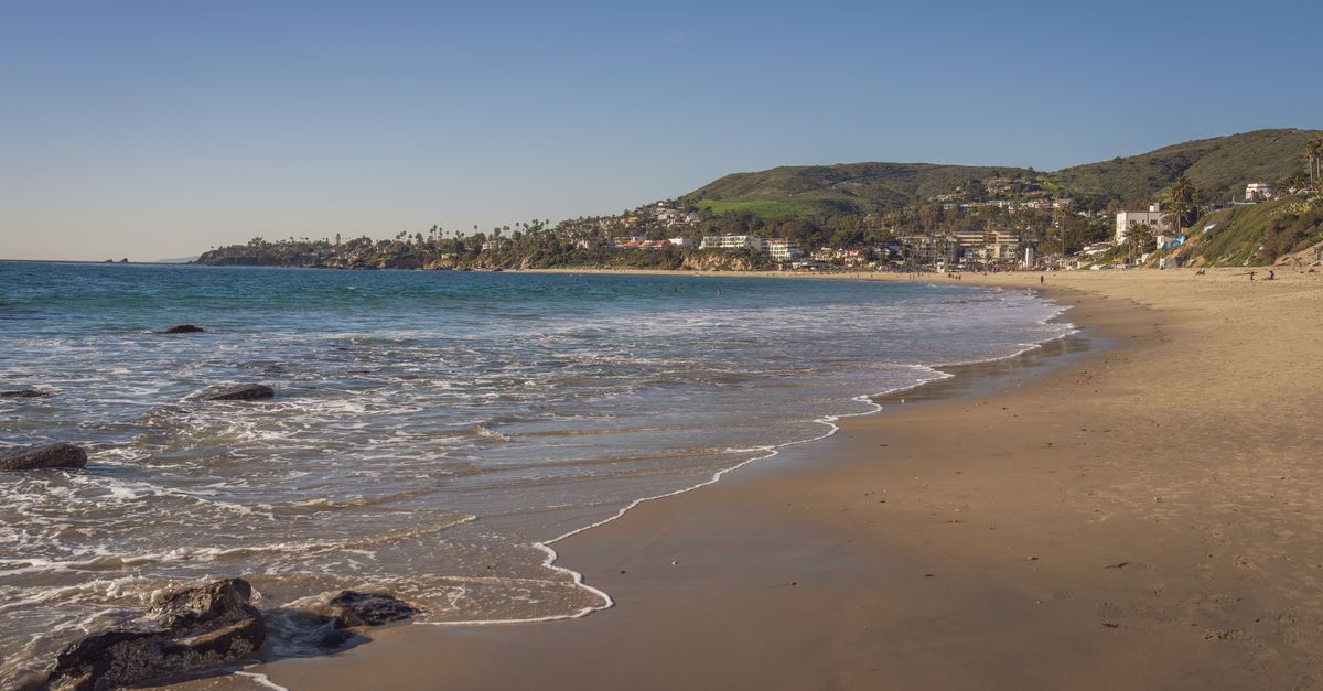 A picturesque view of Laguna Beach with clear skies and gentle waves.